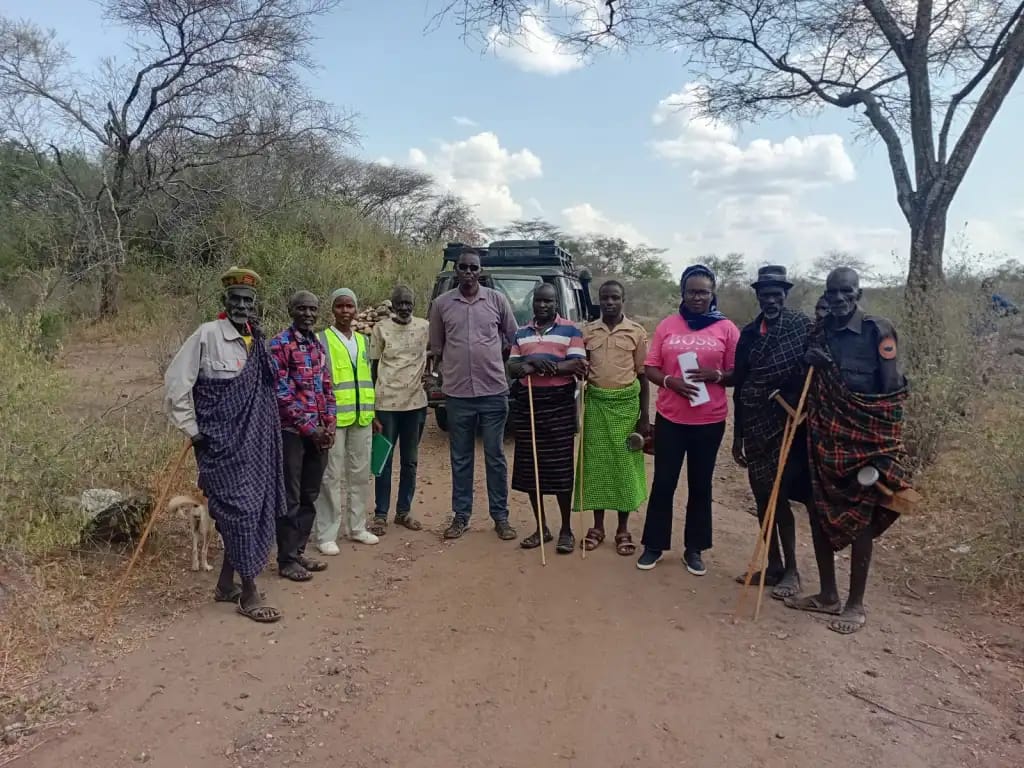 Supervising Engineer Zaika Bilal alongside Surveyor Janet Bosibori and Urum local administrators handing over the 9.4-km road project site to the contractor.