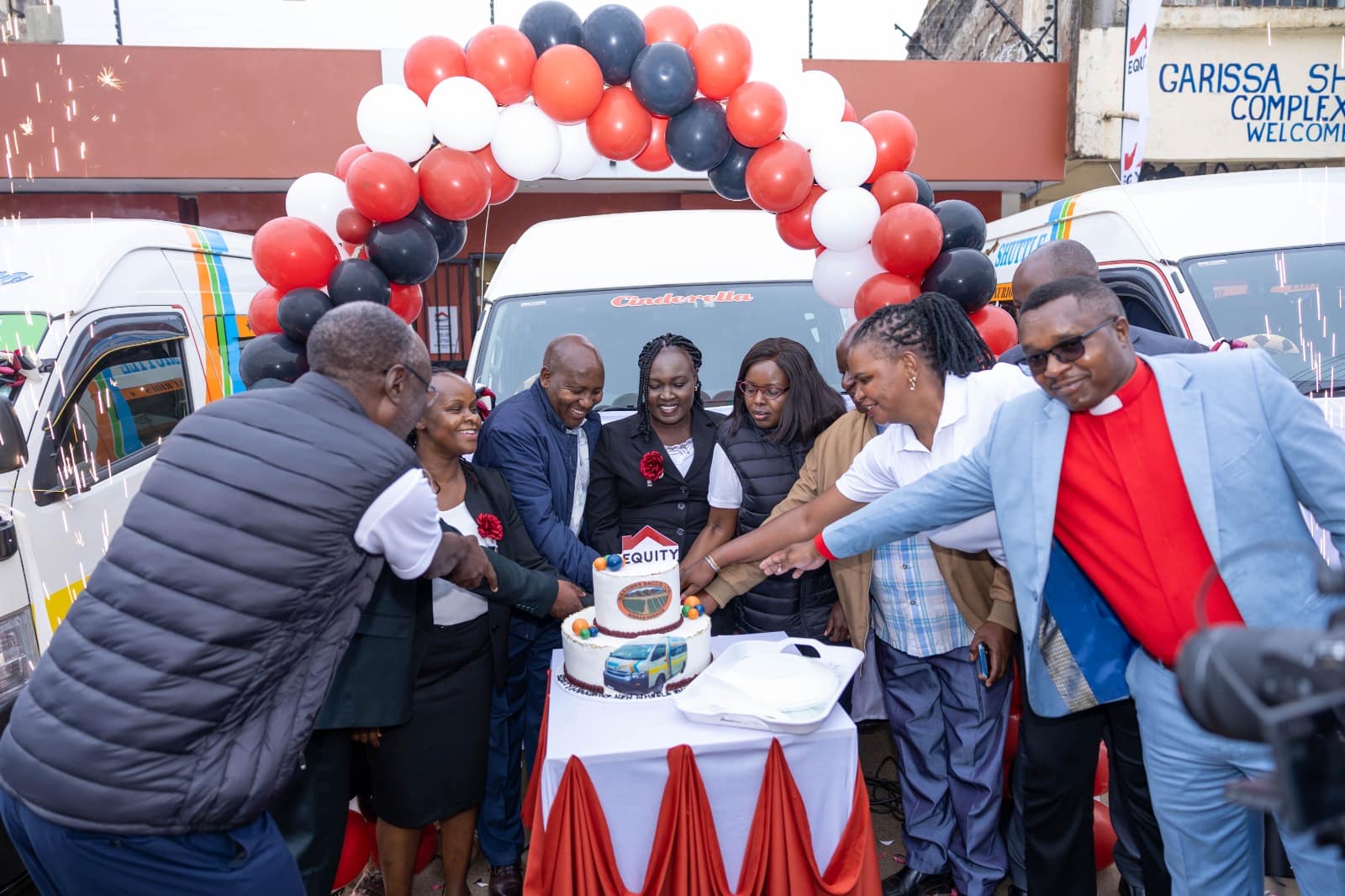 Equity Bank officials and NAKKONS Sacco members during the launch of seven new public service vehicles in Othaya, Nyeri County.