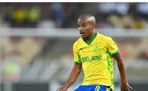 Midfielder Jayden Adams sporting the yellow and green South African national football jersey during a competitive international match.