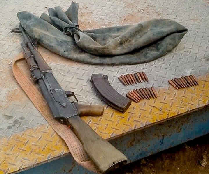 File image representing an automatic rifle and ammunition cache recovered during a civilian weapons surrender program."