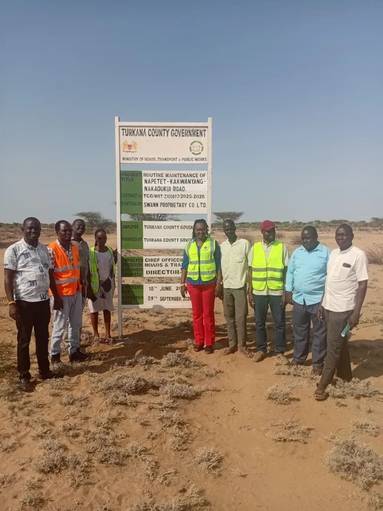 Deputy Director Julia Agis, Surveyor Janet Bosibori, and Turkana County engineering officials inspecting the completed grading works on the Napetet-Nakadukui Road.